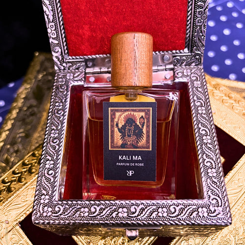 Parayan O Rakkhoshgon Kali Ma parfum de Robe fragrance bottle with wooden cap in a red and silver ornate box