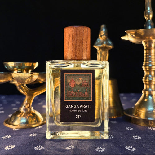 Parayan O Rakkhoshgon Ganga Arati Parfum de Robe fragrance bottle with Arati utensils in background